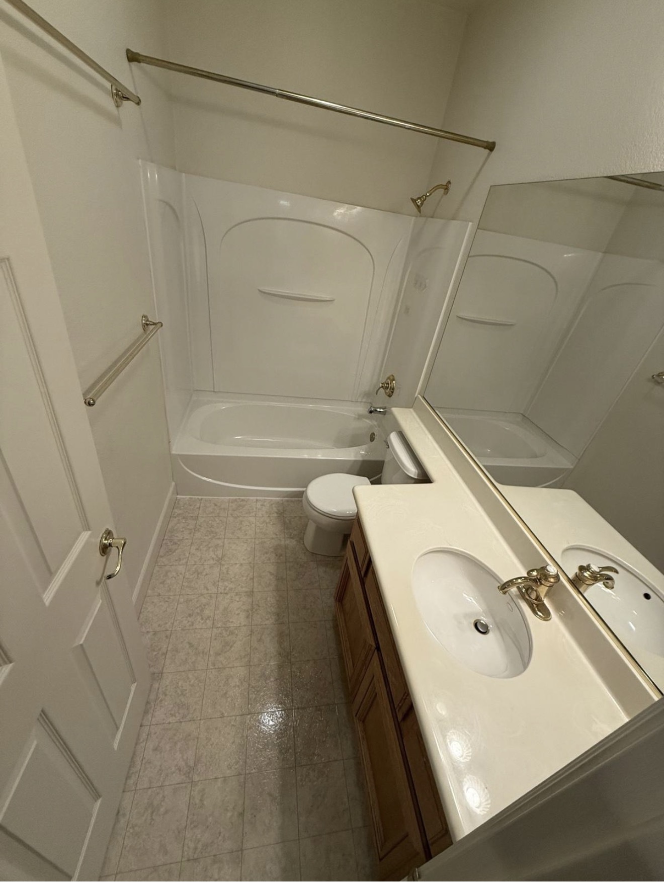 Vacant bathroom prepped for inspection with spotless tub and sinks