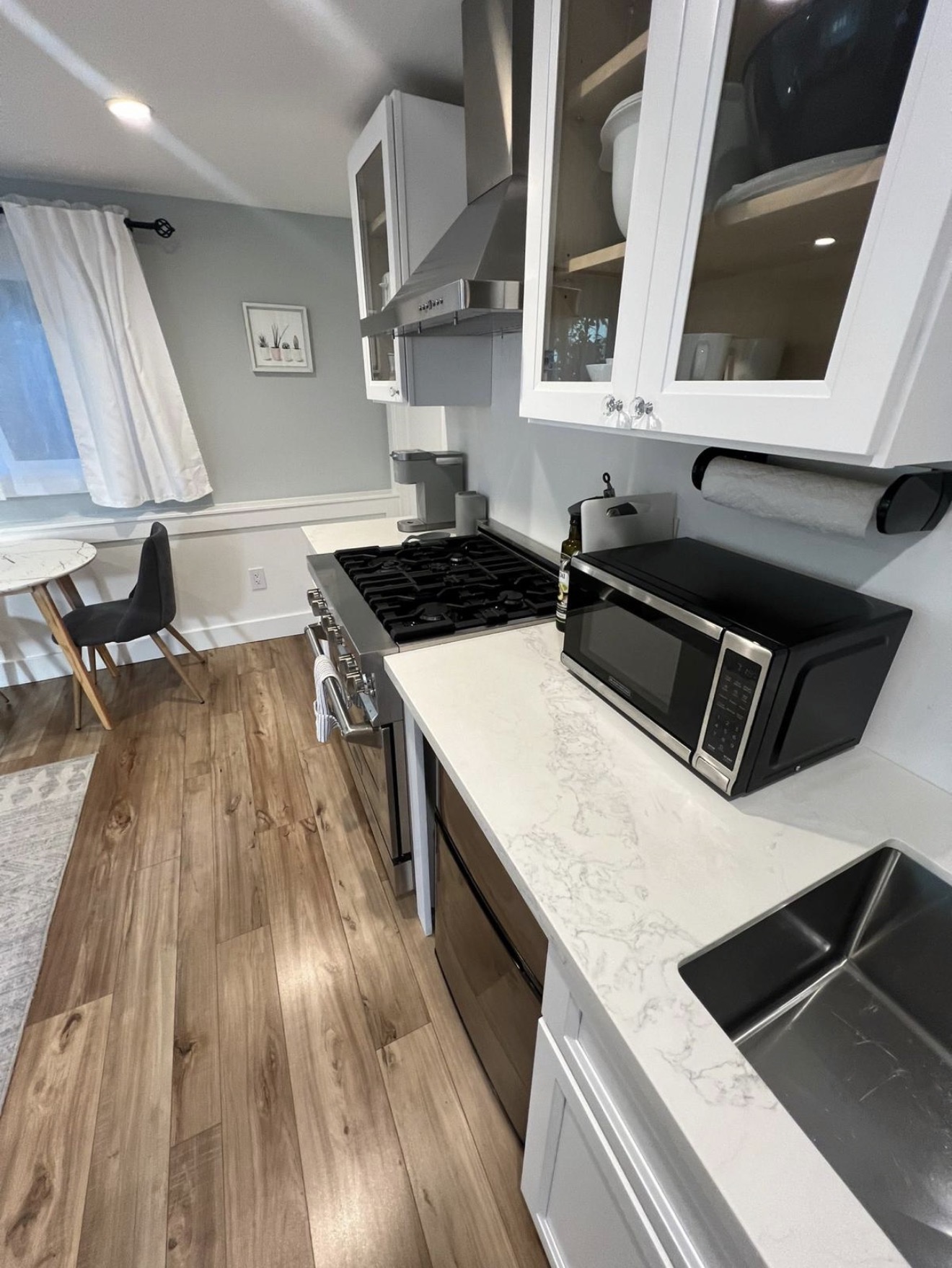 Modern white kitchen with polished quartz counters after Go Live Cleaning