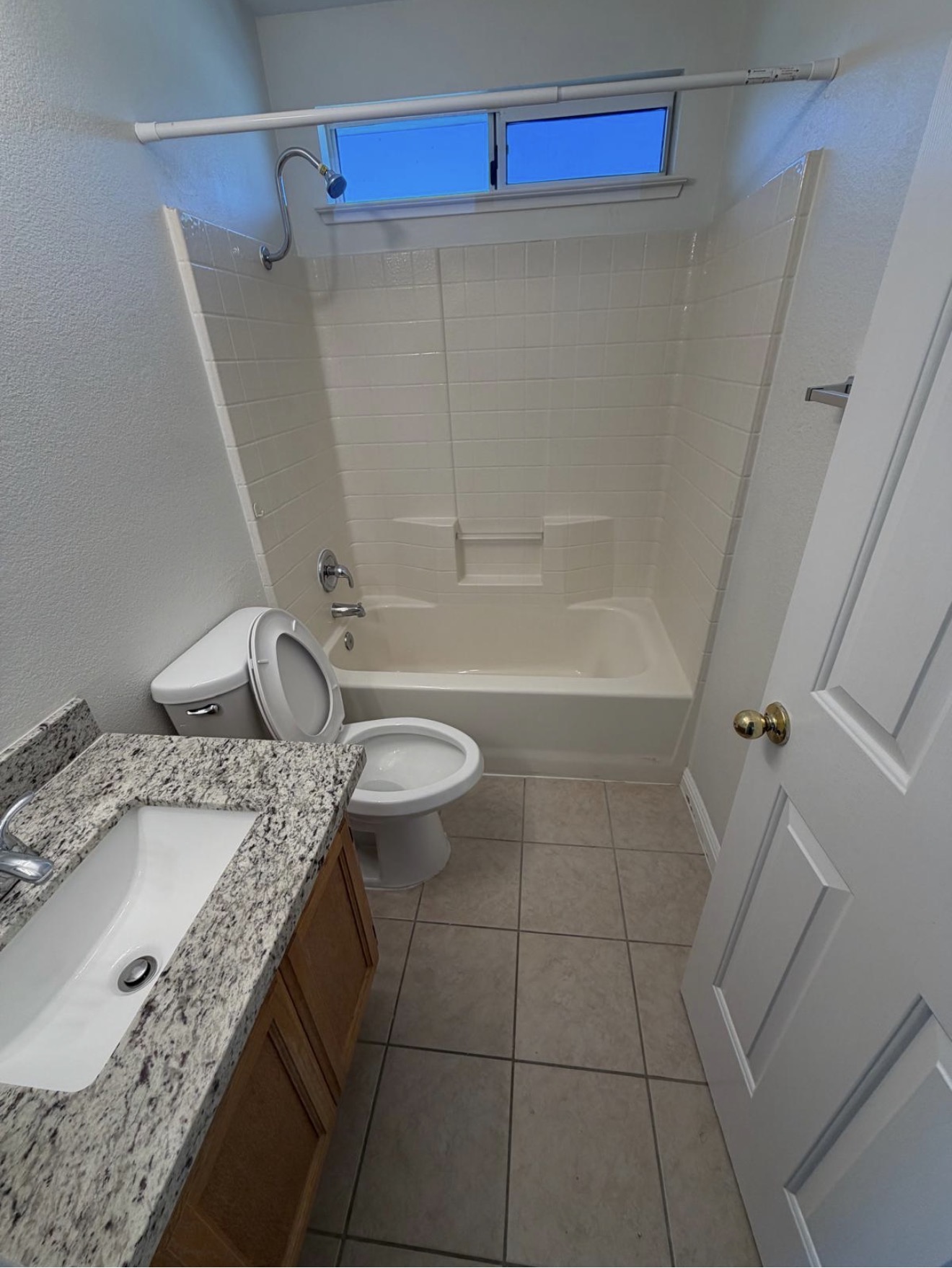Empty bathroom with tub, toilet, and vanity fully sanitized