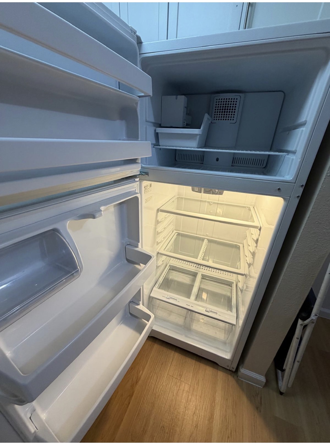 Refrigerator interior fully cleaned, shelves and drawers detailed