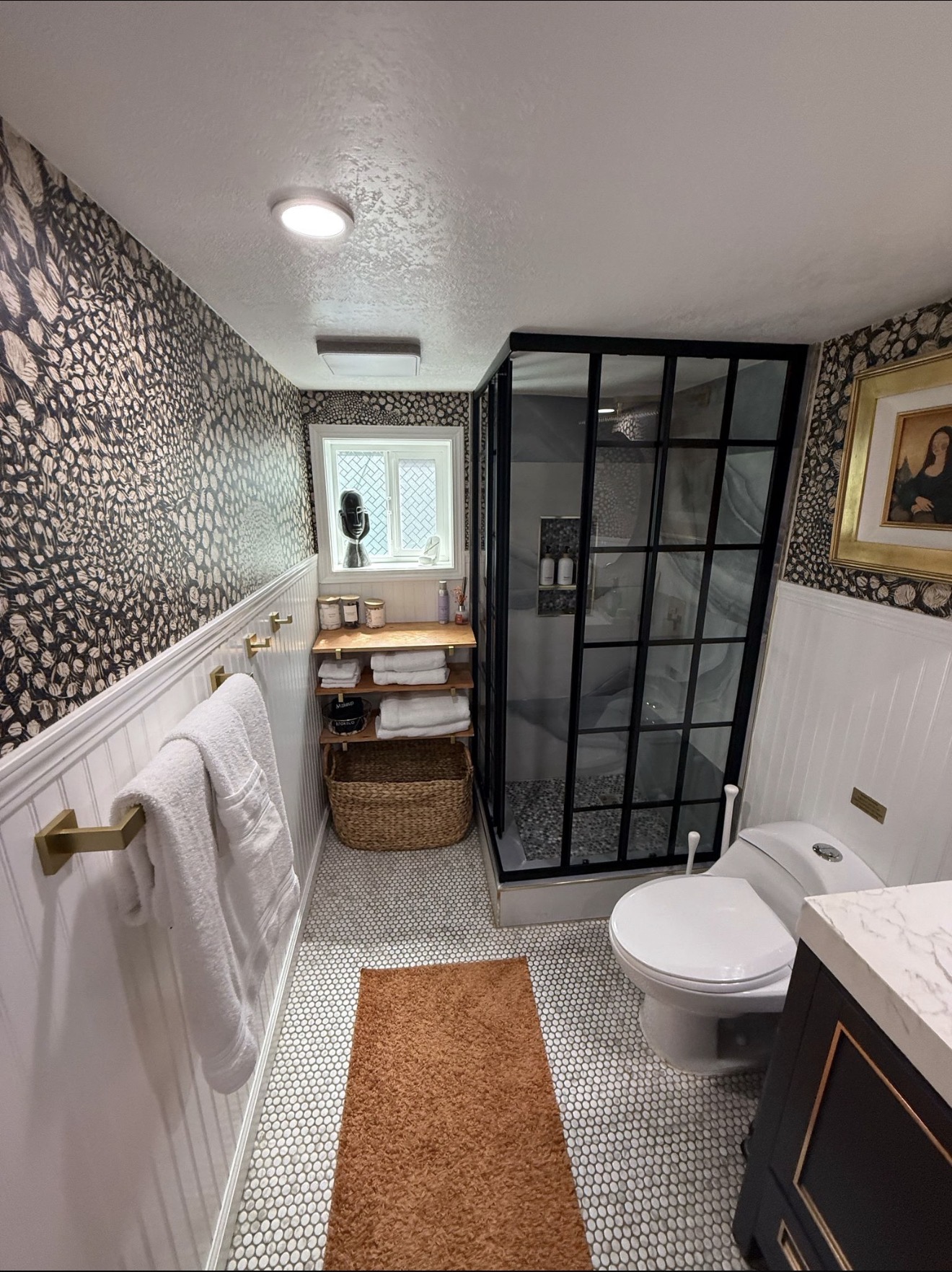 Designer bathroom with black-framed shower deep-cleaned to a shine